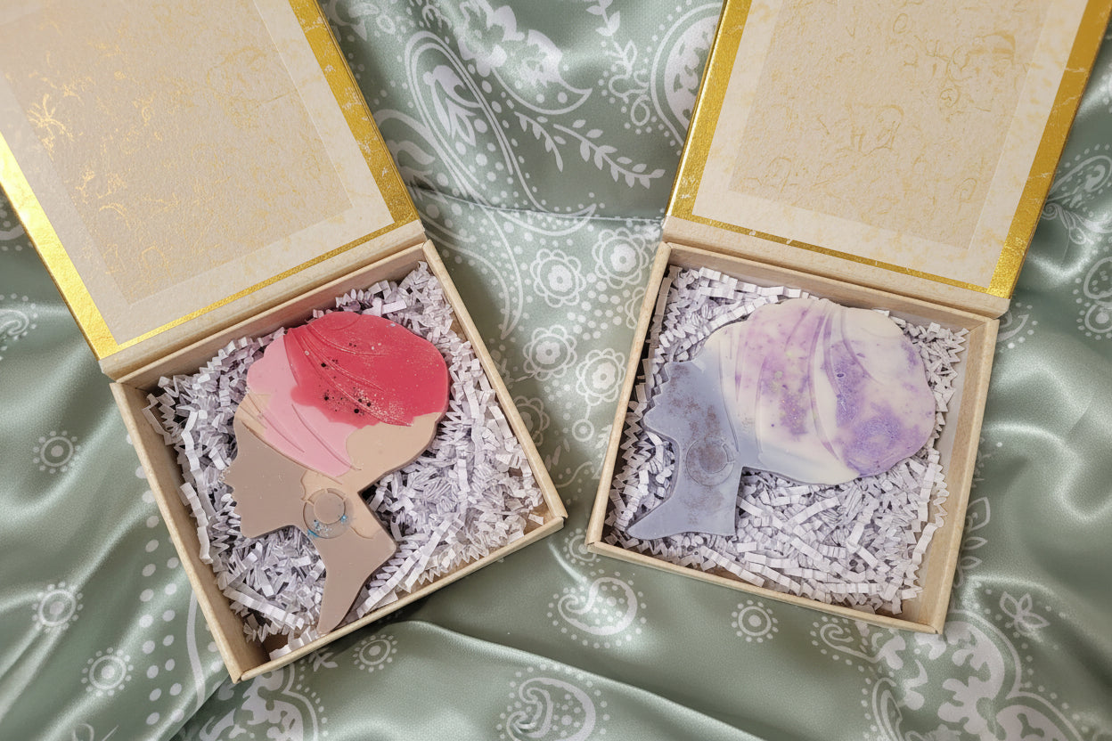 Two hair hand poured wax melts, one pink and one purple, in gift box